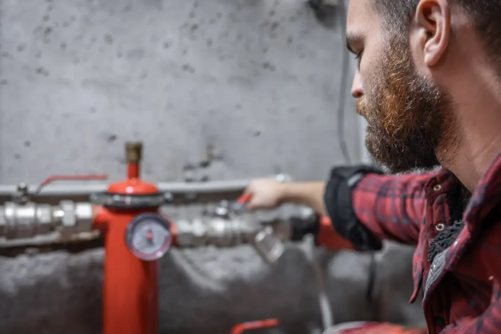 Un tecnico esperto ispeziona una caldaia per ottimizzare il risparmio energetico e ridurre i consumi domestici.